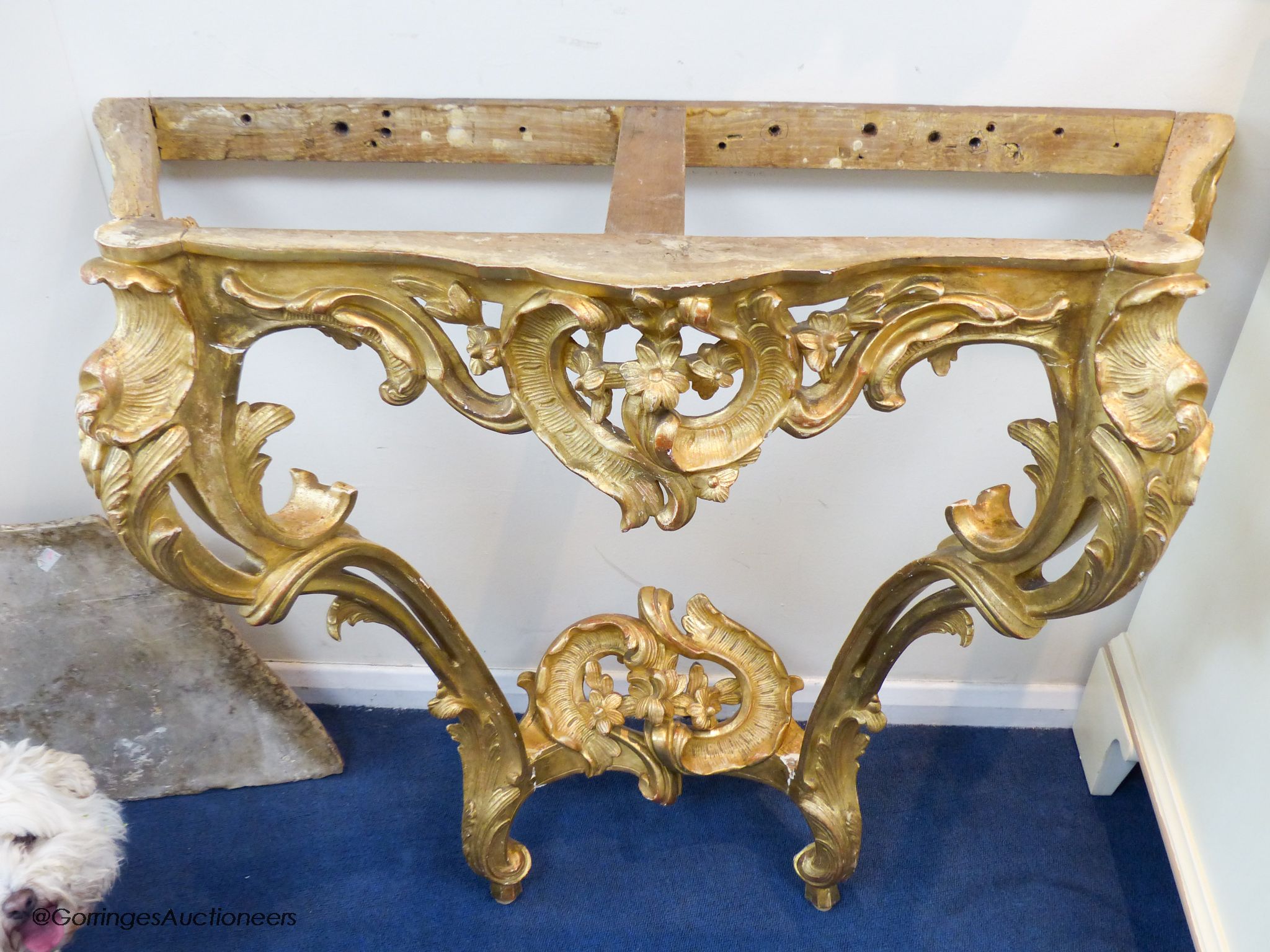 A 19th century rococo revival giltwood console table, 95cm wide, 86.5cm high and a similar later giltwood mirror, 113cm high, 64.5cm wide